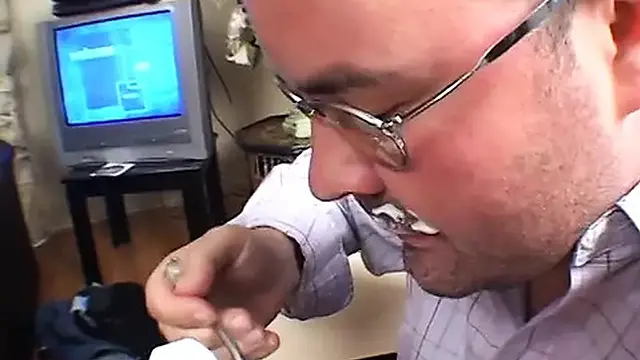 Muscular man and voluptuous brunette lock lips by the pool as another man watches intently