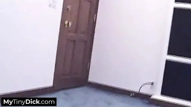 A hot brunette tattooed temptress sucking his small cock