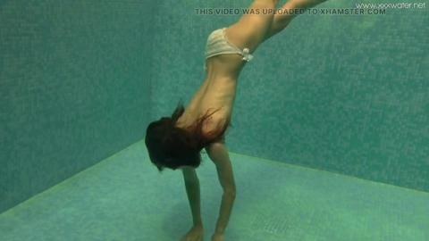 Slutty Irina Russaka strips naked and fucks under the surface like a fishy floozy